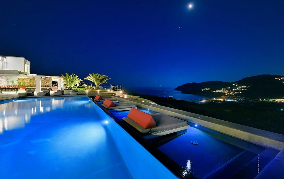 Night view of Villa KLD Mykonos showcasing its luxurious infinity pool and stunning sea views