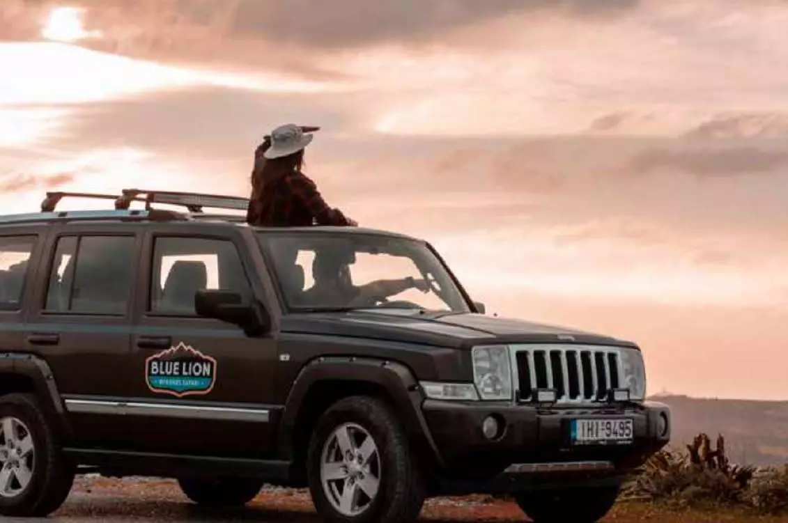 Adventurous travelers on a safari jeep exploring the rugged landscapes of Mykonos